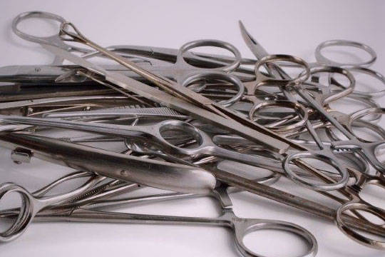 Pile of rusty, dirty surgical instruments