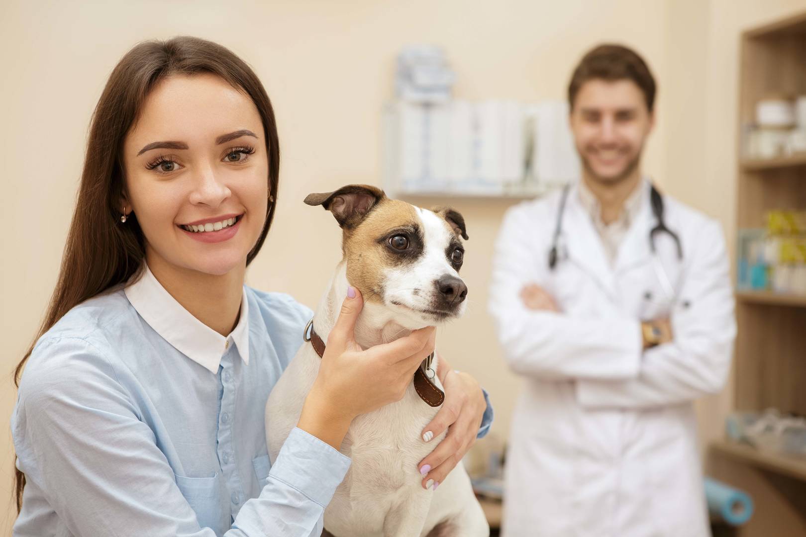 pet owner with dog in vet exam room